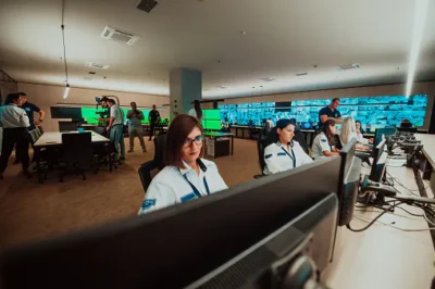 Group of female security operators working in a data system control room Technical Operators Working at workstation with multiple displays, security guards working on multiple monitors in surveillan